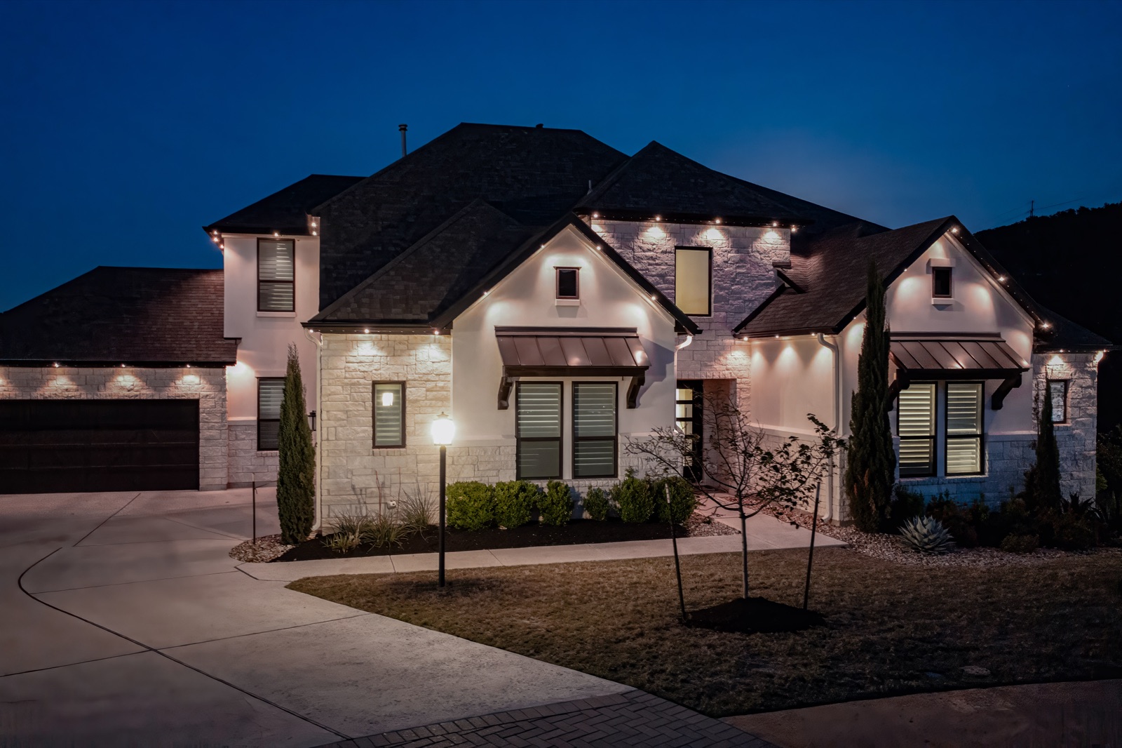 Luxury home with warm white architectural roofline lighting