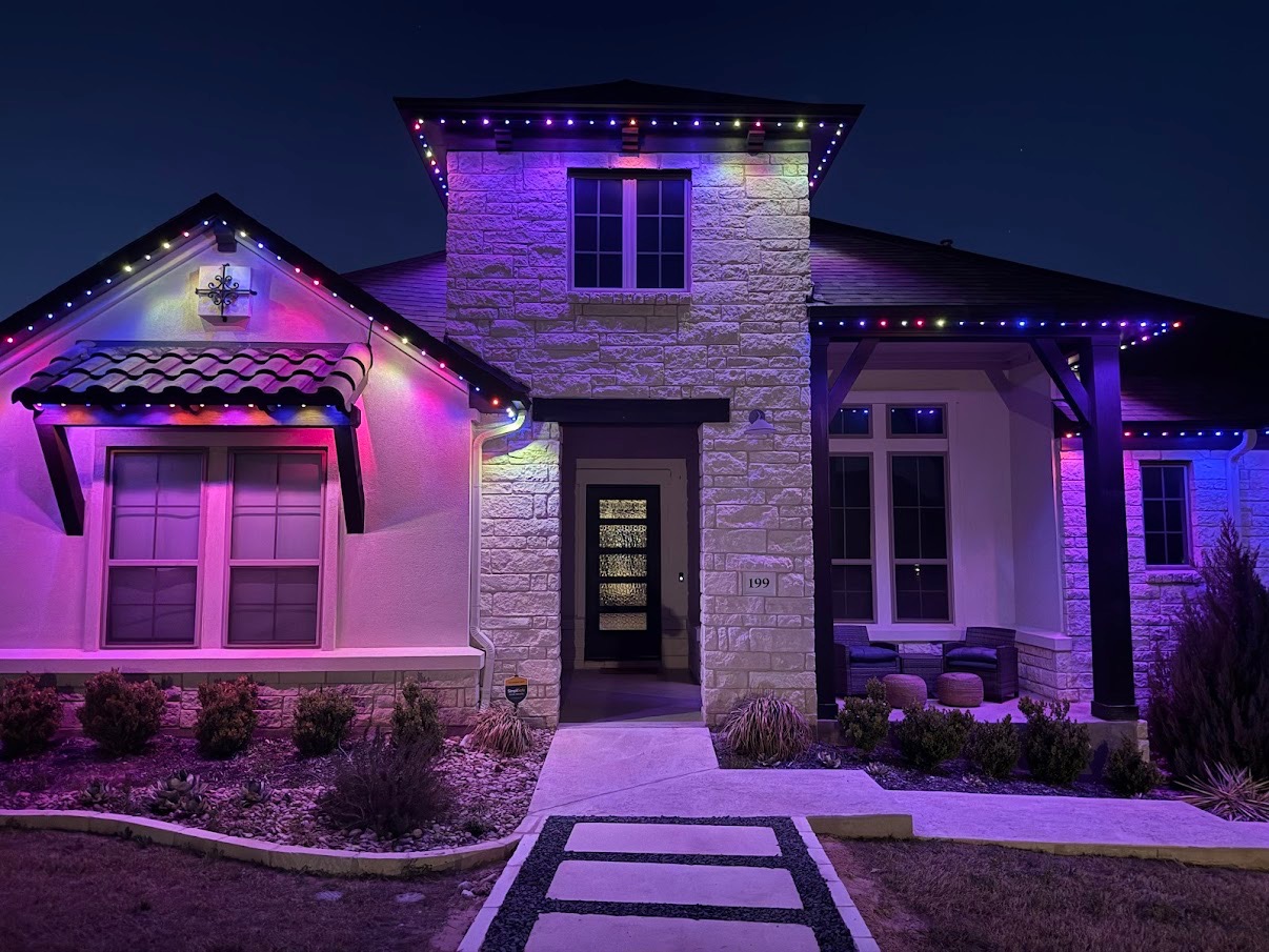 Home with colorful permanent roofline lighting in pink, purple, and blue